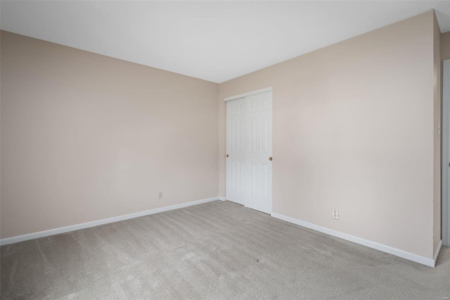 unfurnished room with carpet and baseboards