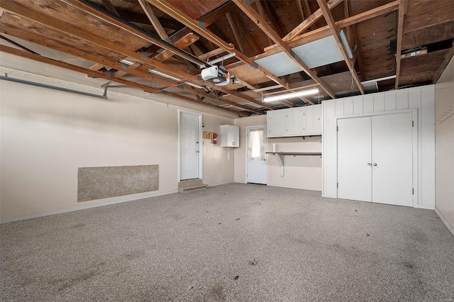 garage with a garage door opener and baseboards