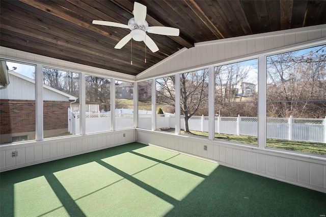 unfurnished sunroom with a ceiling fan, vaulted ceiling, and wood ceiling