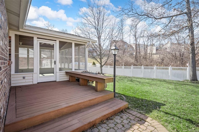 wooden deck with fence, a lawn, and a sunroom