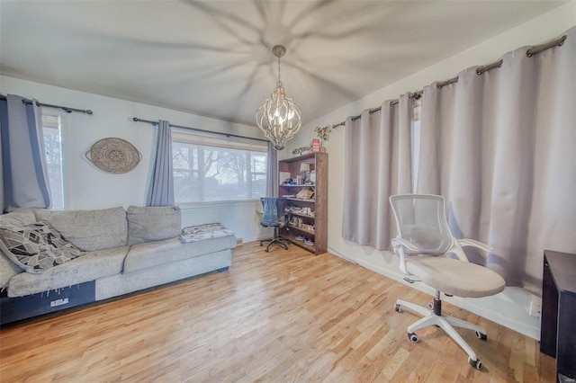 office area featuring a notable chandelier and wood finished floors