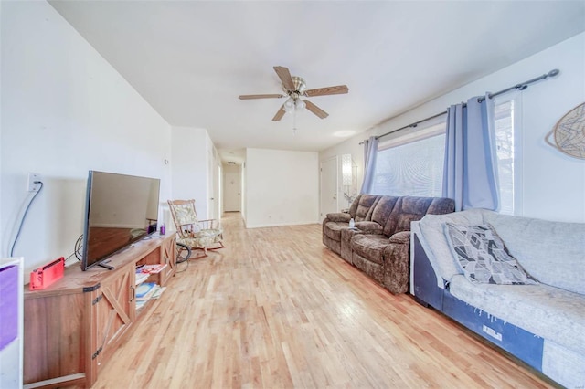 living room featuring ceiling fan and wood finished floors