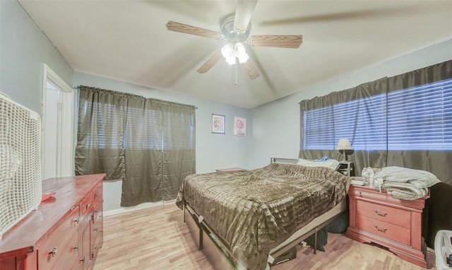 bedroom with ceiling fan and light wood-style flooring