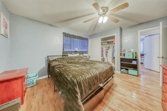 bedroom with a ceiling fan, baseboards, light wood-style floors, a closet, and a baseboard heating unit