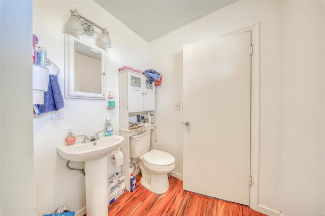 bathroom featuring toilet and wood finished floors