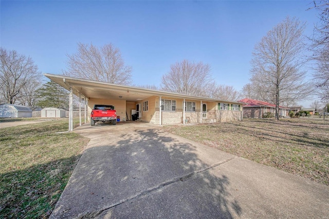 ranch-style home with a front yard, a shed, driveway, covered porch, and a carport