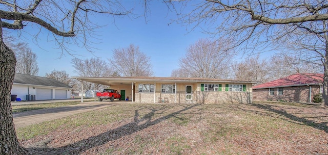 view of front of home with an outbuilding, central AC unit, driveway, covered porch, and a carport