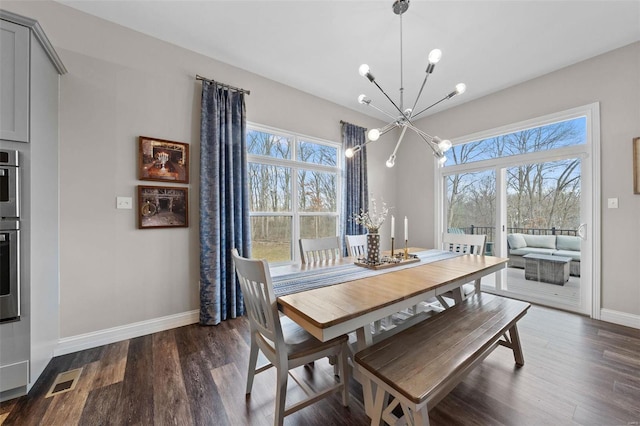 dining space with an inviting chandelier, visible vents, baseboards, and dark wood-type flooring