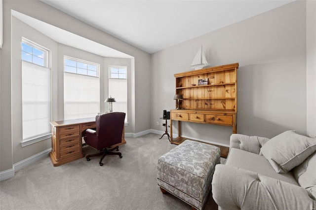 home office featuring baseboards and light colored carpet