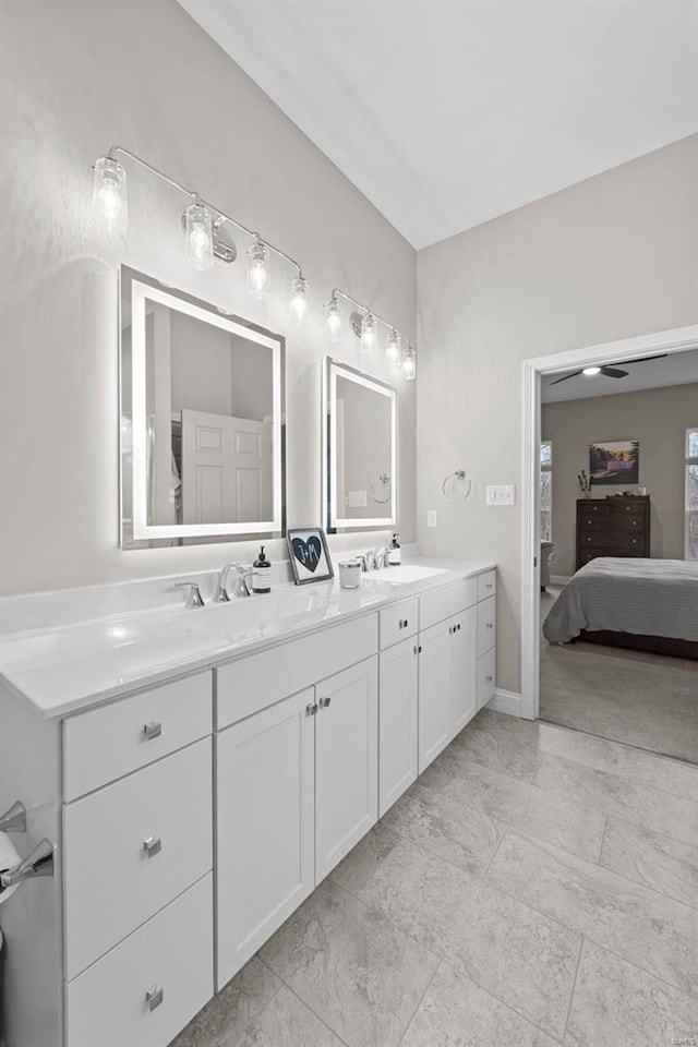 bathroom featuring a sink, ensuite bath, and double vanity