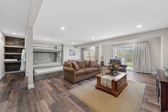 living area with dark wood-style floors, baseboards, and recessed lighting