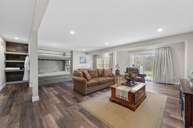 living room featuring baseboards, dark wood-type flooring, and recessed lighting