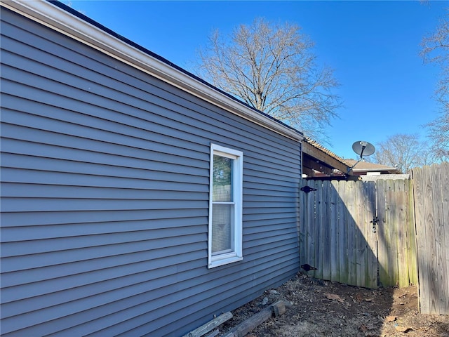 view of side of home with fence