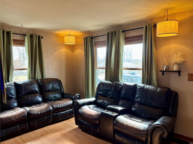 living room with plenty of natural light and wood finished floors