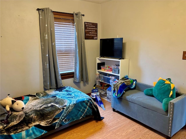 bedroom with wood finished floors