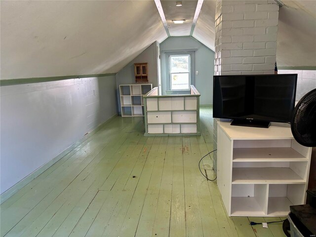 bonus room with lofted ceiling and light wood-style flooring