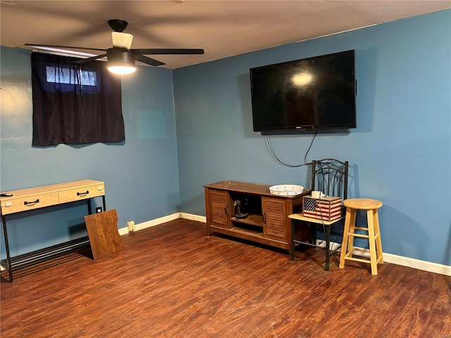 interior space with ceiling fan, wood finished floors, and baseboards