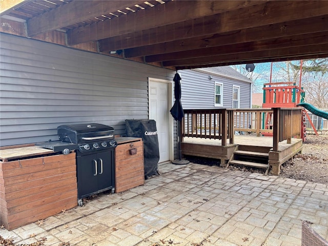 view of patio / terrace featuring a playground and area for grilling