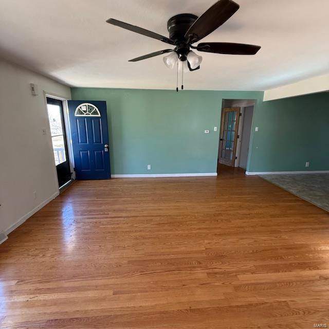 entryway with a ceiling fan, baseboards, and light wood finished floors