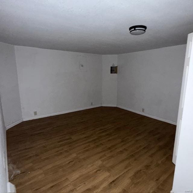 unfurnished room with wood finished floors and baseboards