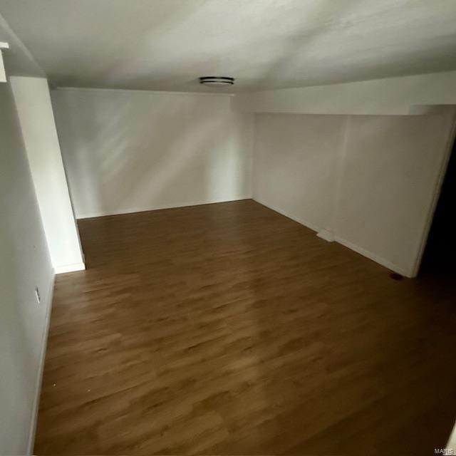 additional living space featuring wood finished floors