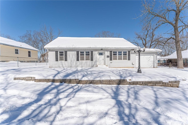 view of front of house with a garage and fence