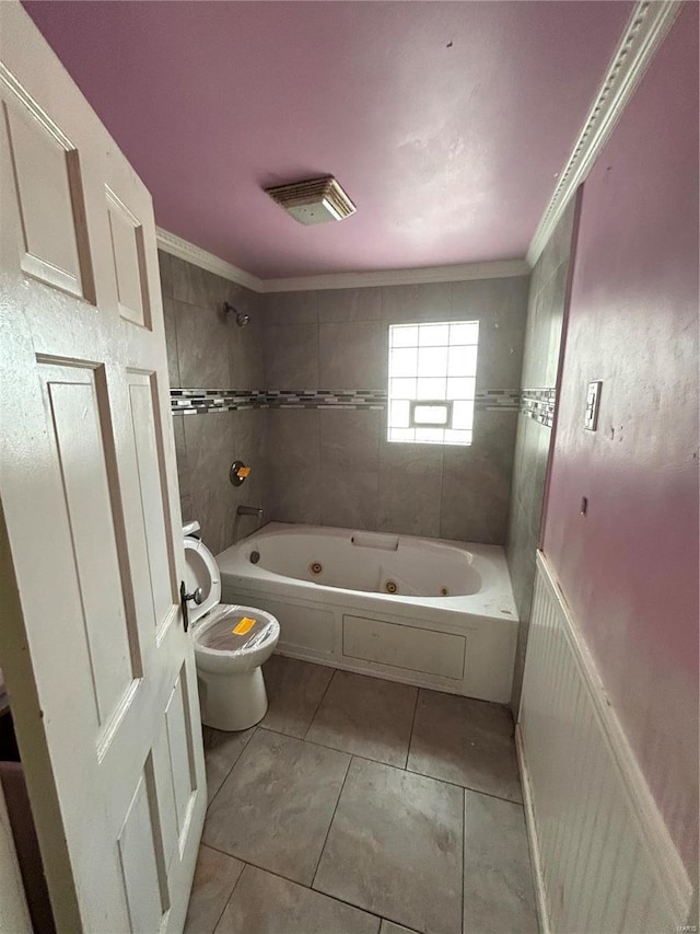 bathroom featuring toilet, tile patterned floors, ornamental molding, and a combined bath / shower with jetted tub