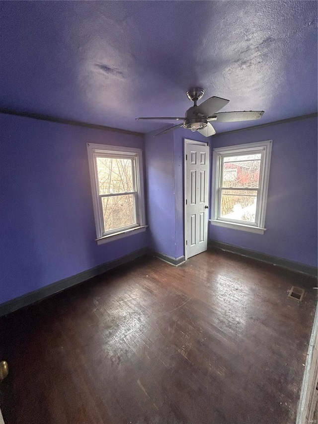 empty room with plenty of natural light, visible vents, and baseboards