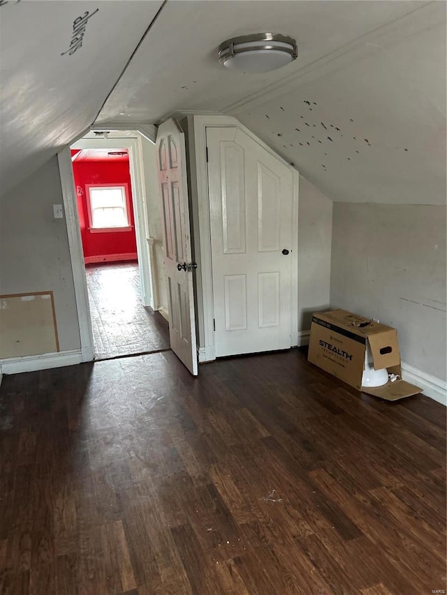 bonus room featuring lofted ceiling, baseboards, and wood finished floors