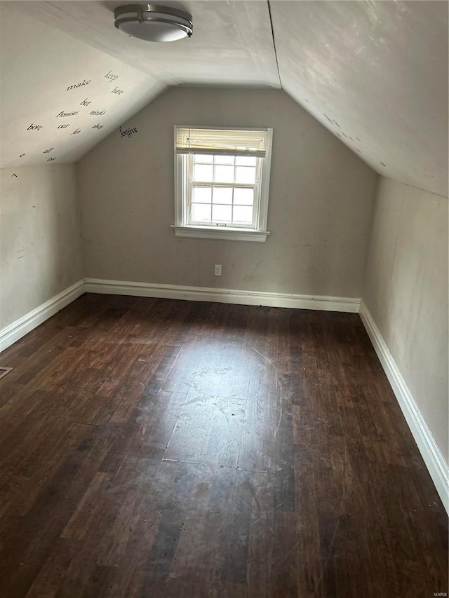 bonus room with vaulted ceiling, baseboards, and dark wood finished floors