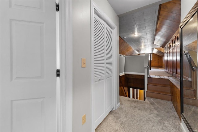 hallway featuring carpet and vaulted ceiling