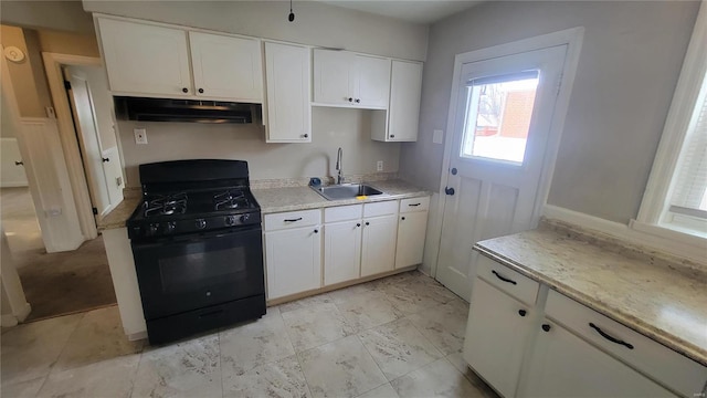 kitchen with black range with gas stovetop, a sink, white cabinets, and under cabinet range hood