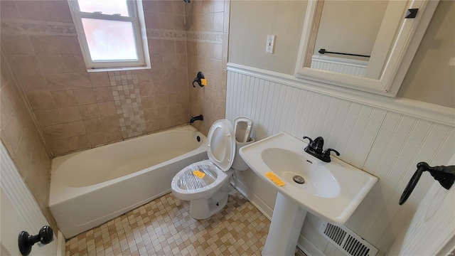 full bath with tile patterned flooring, toilet, a wainscoted wall, visible vents, and tub / shower combination