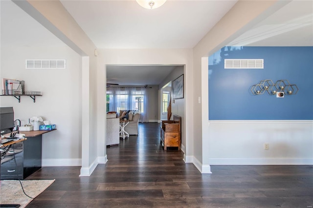 entrance foyer with wood finished floors, visible vents, and baseboards