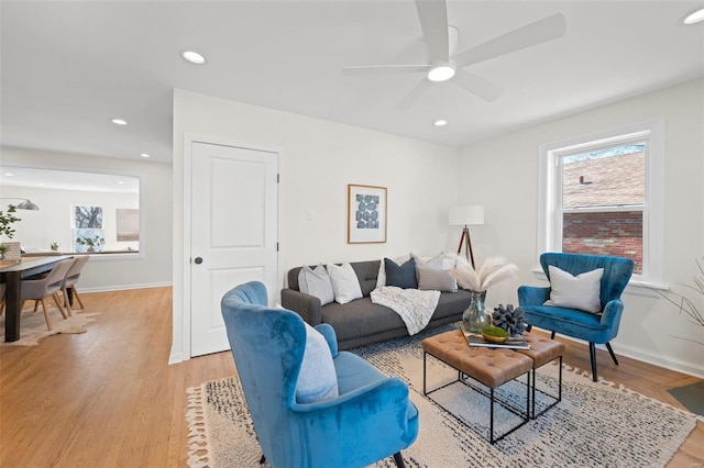 living room featuring recessed lighting, light wood-style flooring, and baseboards