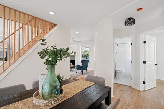 dining area with recessed lighting, stairway, light wood-style floors, a fireplace, and baseboards