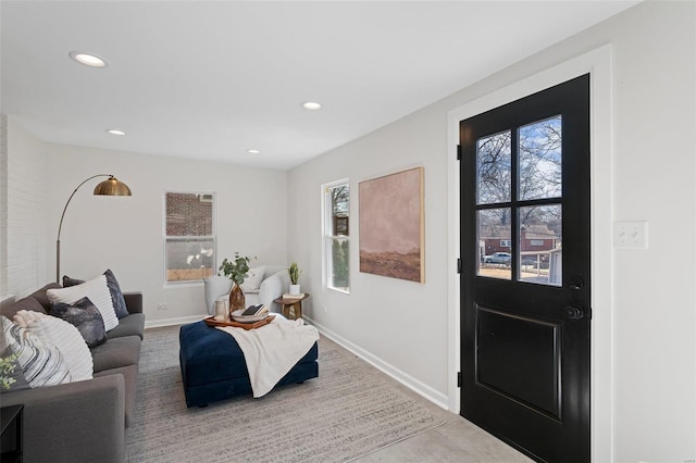 living room with a wealth of natural light, recessed lighting, and baseboards