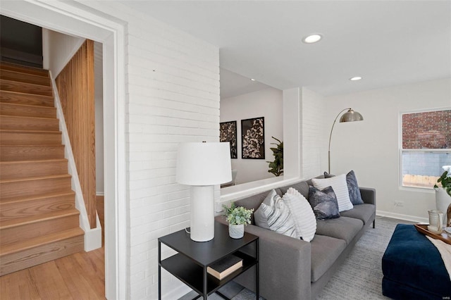 living room with stairs, recessed lighting, wood finished floors, and baseboards