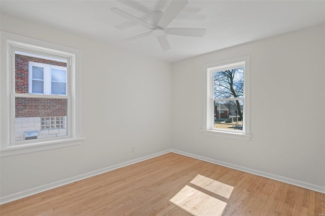 unfurnished room featuring ceiling fan, baseboards, and wood finished floors