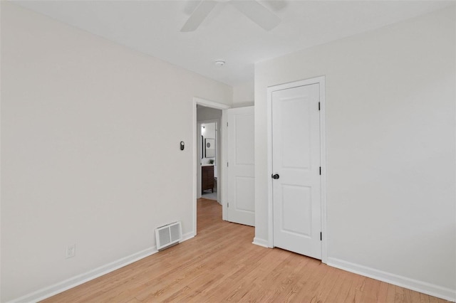 unfurnished room featuring visible vents, baseboards, ceiling fan, and light wood finished floors