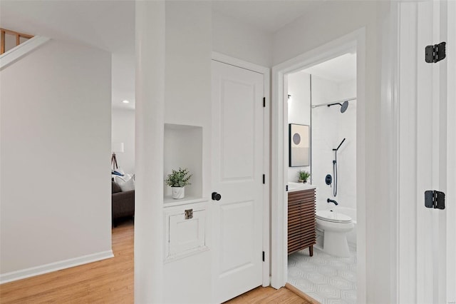 interior space with baseboards and light wood-style flooring