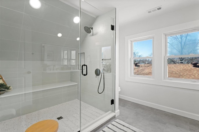 bathroom with visible vents, baseboards, and a shower stall