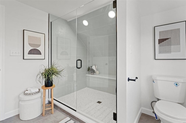 full bath with tile patterned flooring, a shower stall, toilet, and baseboards