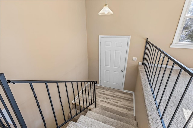 stairs with baseboards and wood finished floors