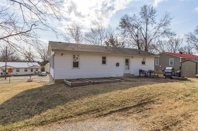 rear view of house with a patio area and a yard