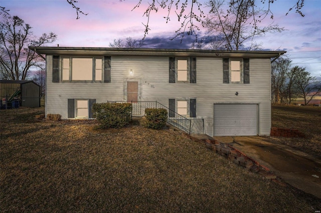 split foyer home featuring a garage and driveway