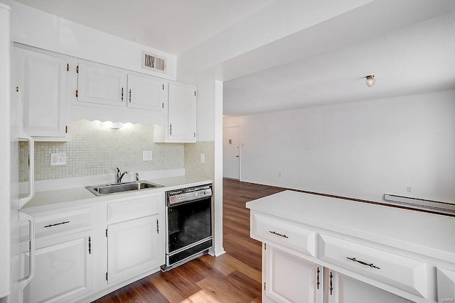 kitchen with visible vents, a sink, black dishwasher, white cabinetry, and light countertops