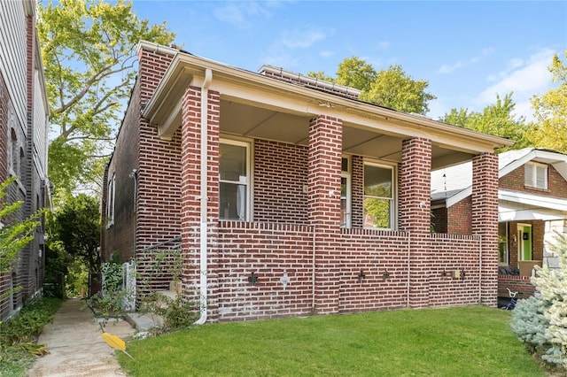 view of home's exterior featuring a yard and brick siding