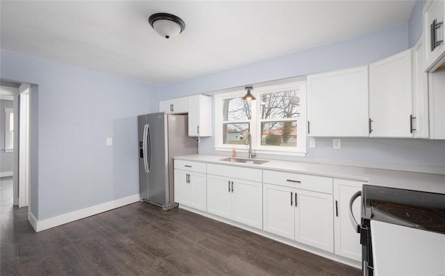 kitchen featuring black / electric stove, dark wood-type flooring, white cabinets, a sink, and baseboards