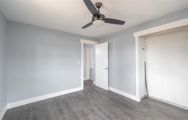 unfurnished bedroom featuring ceiling fan, a closet, wood finished floors, and baseboards